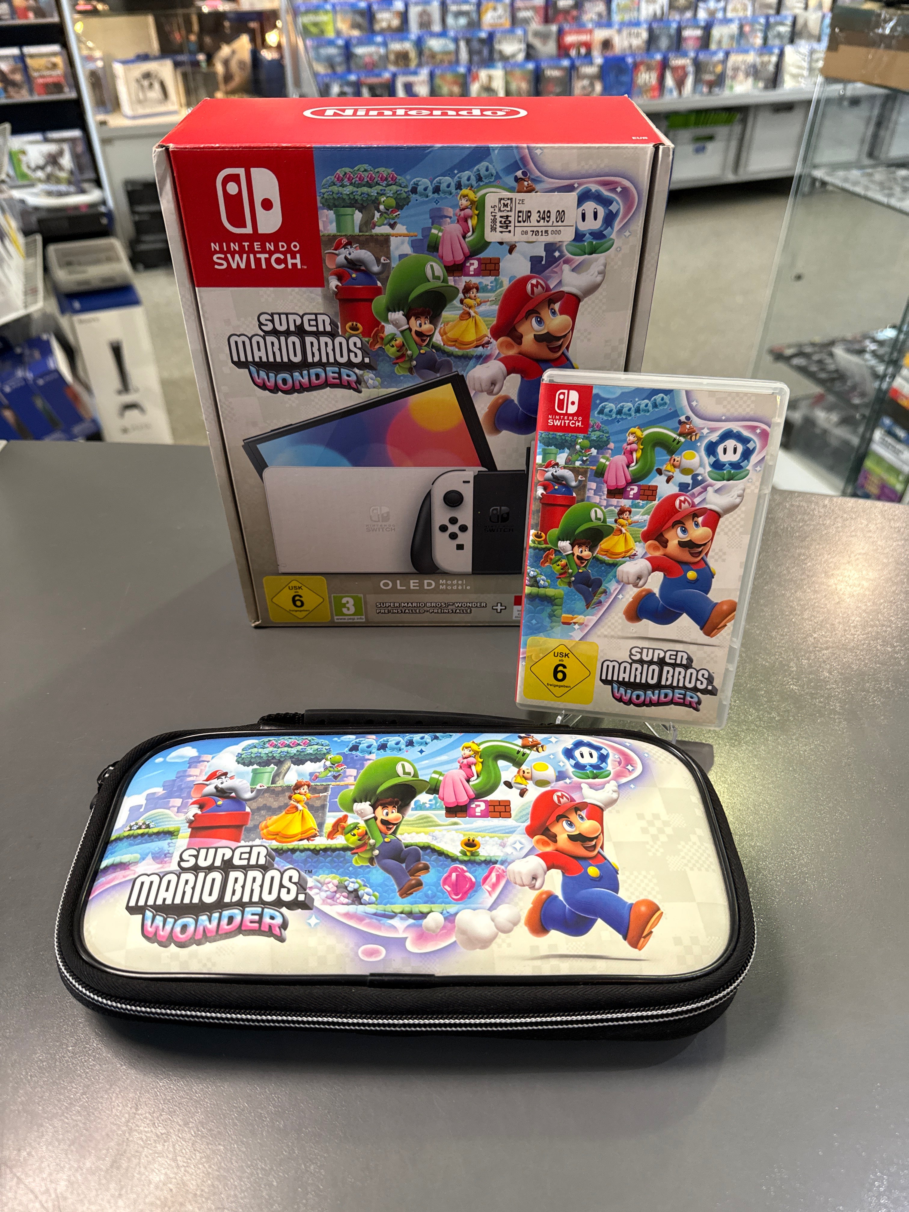Nintendo Switch OLED Konsole in Weiß mit Super Mario Bros. Wonder Spiel, modernes Handheld-Display und farbenfrohes Mario-Artwork.